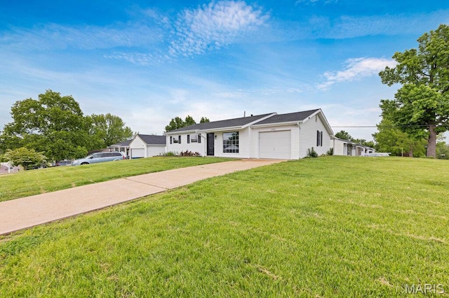 ranch-style house featuring an attached garage, driveway, and a front lawn