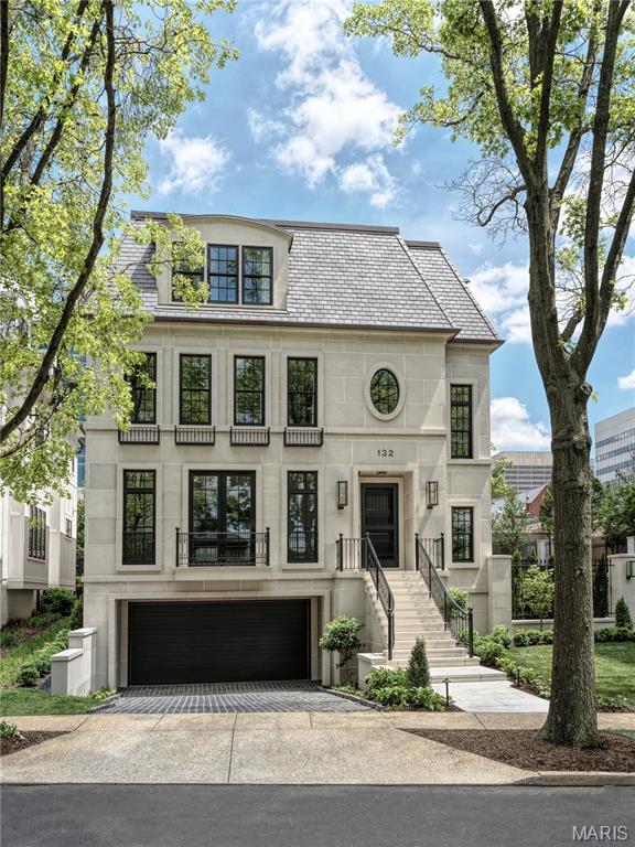 132 N Brentwood Blvd, Clayton, MO 63105 - french country style house with an attached garage, driveway, and stone siding