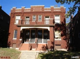 view of front of home featuring brick siding
