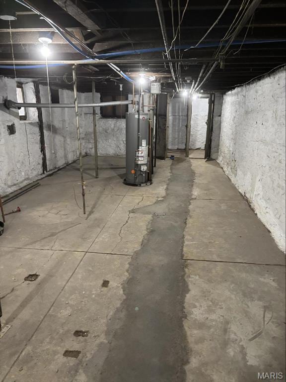 unfinished below grade area featuring water heater