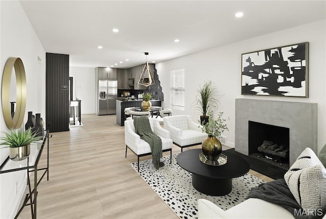 7544 Melrose Ave, University City, MO 63130 - living room featuring light wood-style floors, recessed lighting, a high end fireplace, and baseboards