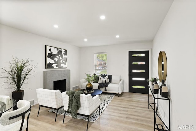 7544 Melrose Ave, University City, MO 63130 - living room with light wood-style flooring, recessed lighting, a fireplace, and baseboards