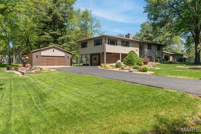1934 Brigantine Cir, Worden, IL 62097 - split foyer home featuring a garage, a chimney, an outbuilding, a front yard, and brick siding