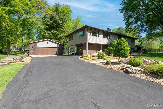 1934 Brigantine Cir, Worden, IL 62097 - view of front of house with an outbuilding, a detached garage, a chimney, and brick siding