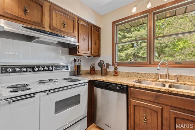 1934 Brigantine Cir, Worden, IL 62097 - kitchen featuring stainless steel dishwasher, electric stove, a sink, under cabinet range hood, and brown cabinetry