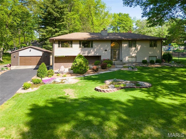 1934 Brigantine Cir, Worden, IL 62097 - raised ranch with an outbuilding, a chimney, a detached garage, and a front lawn