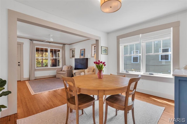 dining room featuring light wood-type flooring and baseboards