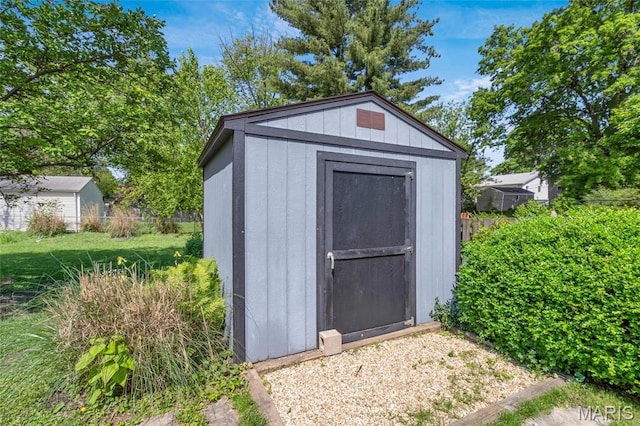 view of shed featuring fence