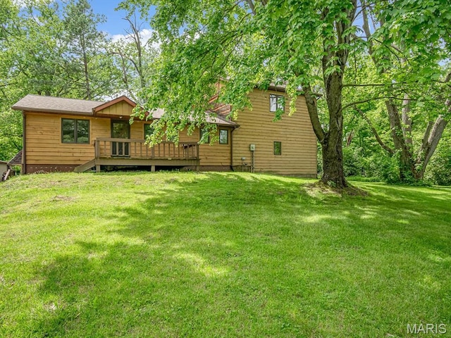 view of green lawn with a deck