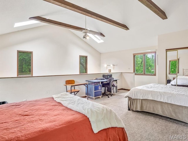 bedroom with a skylight, carpet, a ceiling fan, and baseboards