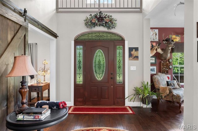 228 Bluegrass Ridge Rd, Saint Clair, MO 63077 - foyer with hardwood / wood-style floors, a high ceiling, a barn door, and baseboards