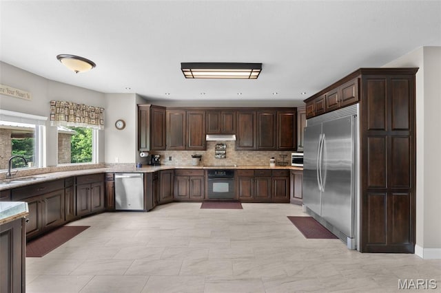 228 Bluegrass Ridge Rd, Saint Clair, MO 63077 - kitchen with appliances with stainless steel finishes, dark brown cabinets, backsplash, and a sink