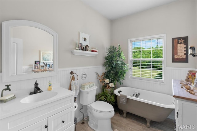 228 Bluegrass Ridge Rd, Saint Clair, MO 63077 - full bathroom featuring wainscoting, wood finished floors, a soaking tub, vanity, and toilet