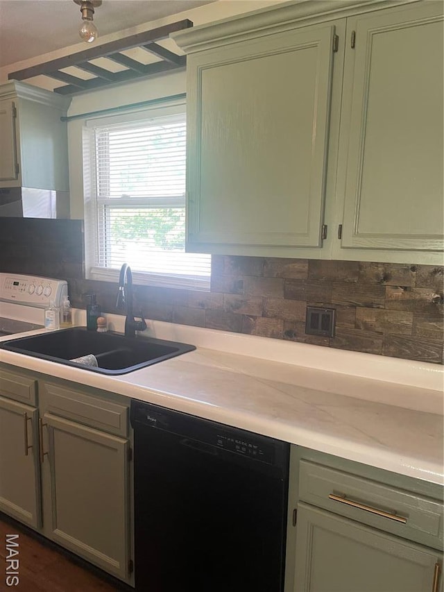kitchen featuring dishwasher, a sink, tasteful backsplash, and light countertops