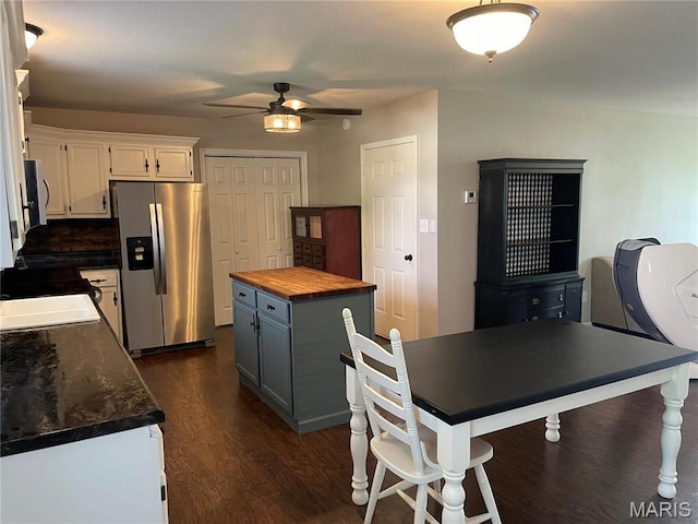 kitchen with stainless steel appliances, butcher block counters, ceiling fan, dark wood-style floors, and white cabinets