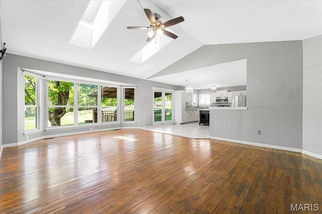 667 Workman Rd, Eureka, MO 63025 - unfurnished living room featuring healthy amount of natural light, ceiling fan, wood-type flooring, a skylight, and high vaulted ceiling