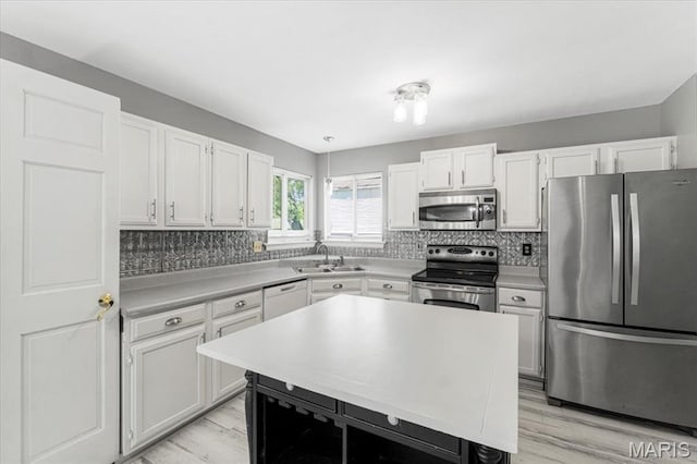 667 Workman Rd, Eureka, MO 63025 - kitchen featuring appliances with stainless steel finishes, backsplash, and light wood finished floors