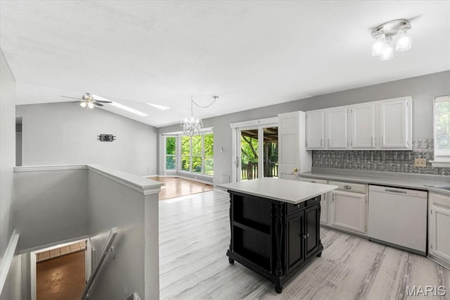 667 Workman Rd, Eureka, MO 63025 - kitchen with dishwasher, light wood finished floors, decorative backsplash, a skylight, and light countertops