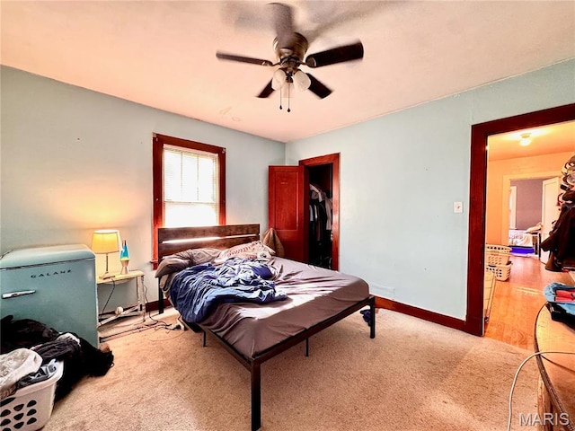 bedroom featuring carpet, baseboards, and a ceiling fan