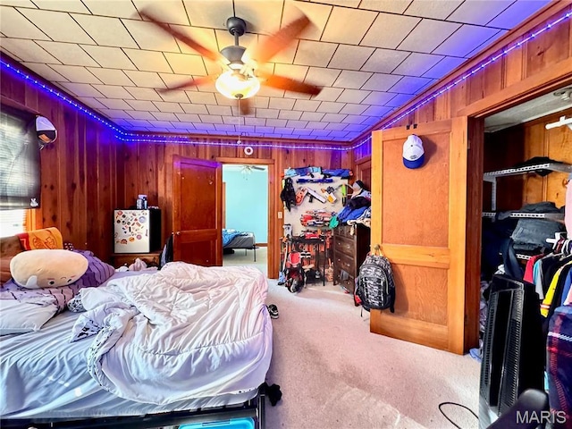 carpeted bedroom with wood walls
