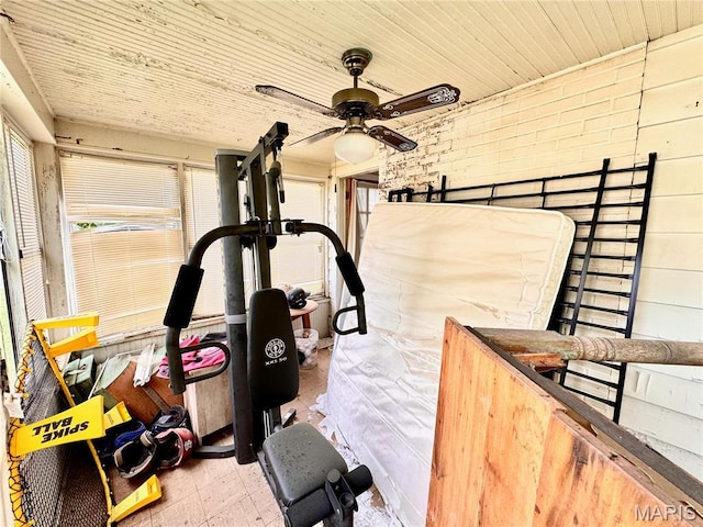 workout room featuring a ceiling fan, wooden ceiling, and tile patterned floors