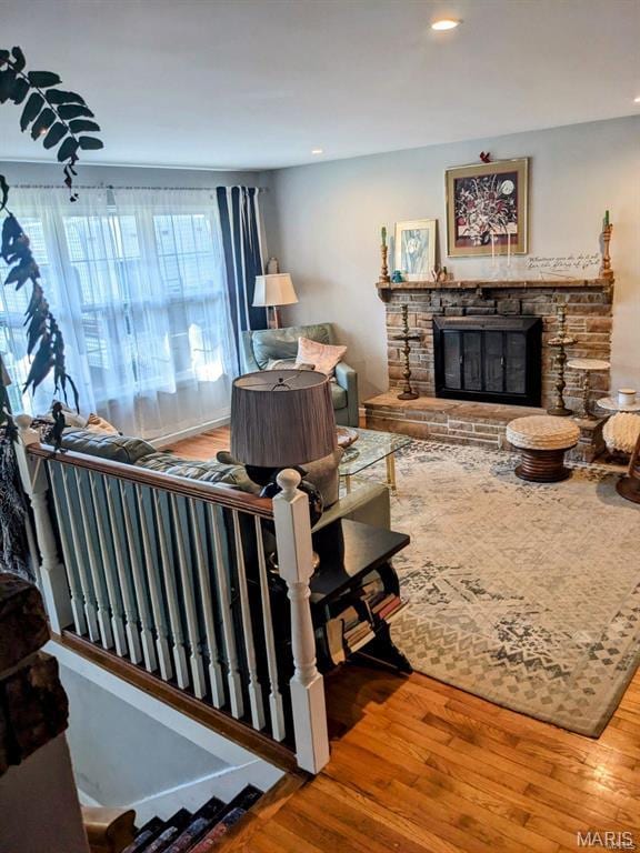 living room with wood finished floors, a fireplace, and recessed lighting