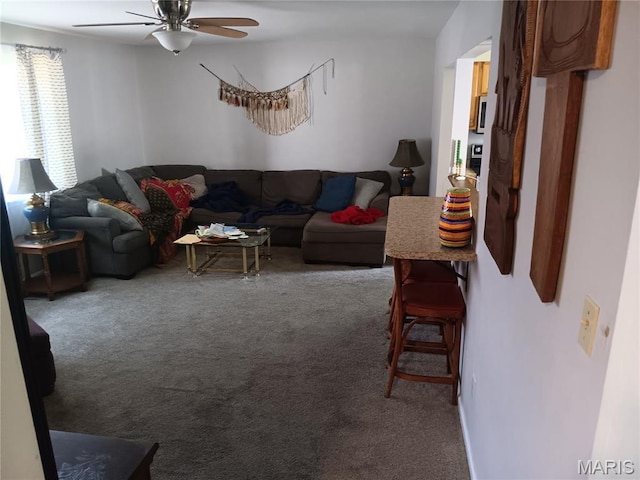 carpeted living room featuring ceiling fan