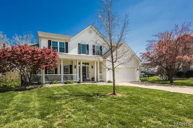 traditional-style house featuring covered porch, driveway, an attached garage, and a front lawn