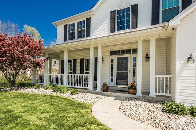 property entrance with a porch and a yard