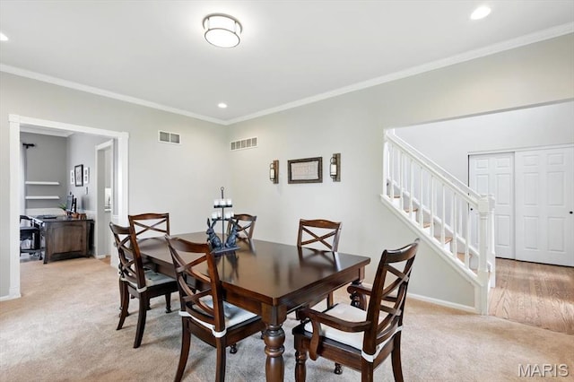 dining area with light colored carpet, crown molding, recessed lighting, stairway, and baseboards