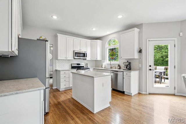 kitchen featuring stainless steel appliances, healthy amount of natural light, light wood-style flooring, and recessed lighting