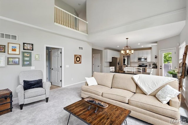 living room with a chandelier, light carpet, baseboards, recessed lighting, and a towering ceiling
