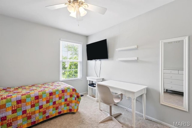 carpeted bedroom featuring baseboards and a ceiling fan