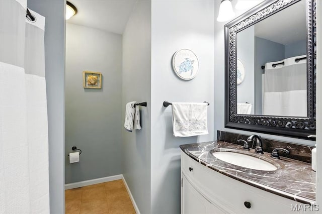 bathroom with tile patterned floors, vanity, and baseboards