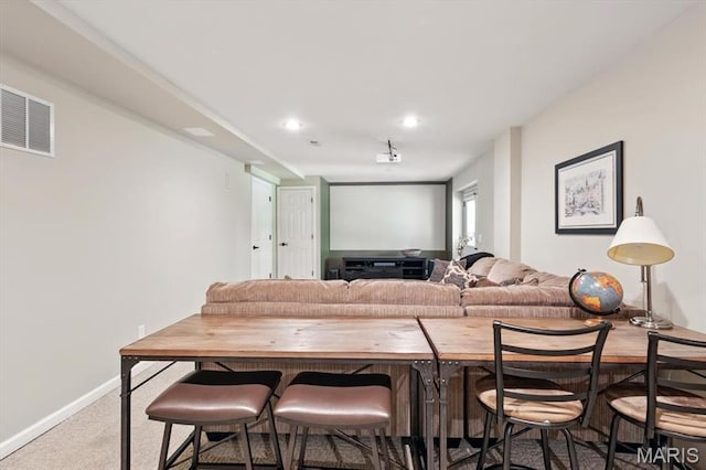 carpeted living room featuring baseboards and recessed lighting