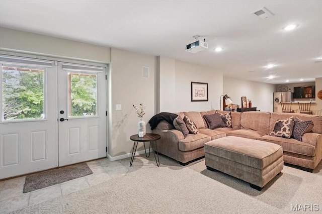 living room featuring french doors, recessed lighting, baseboards, and light tile patterned floors