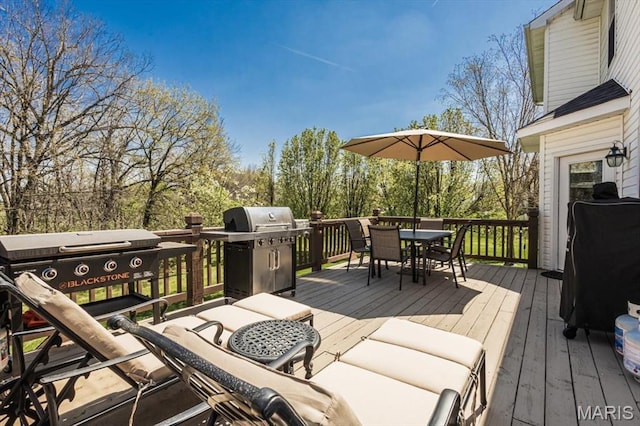 deck with outdoor dining space and area for grilling