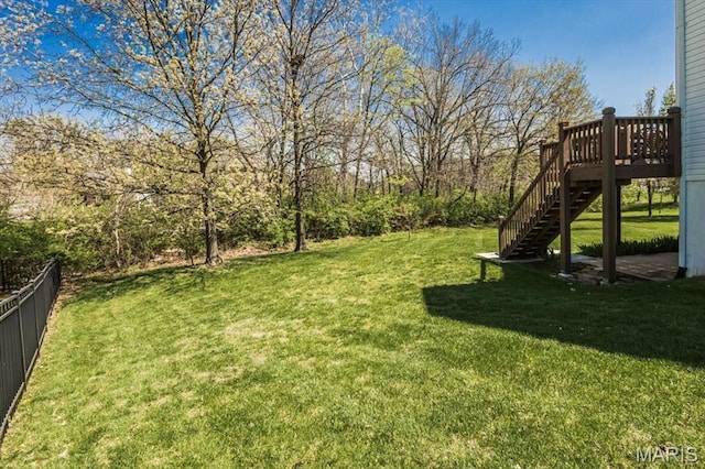 view of yard with stairs and a deck