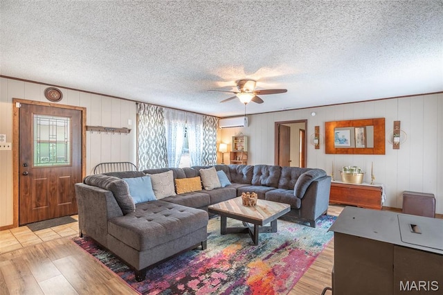 167 Ripley Co Rd Unit Y-3, Doniphan, MO 63935 - living area featuring light wood finished floors, a wall mounted air conditioner, ceiling fan, and a textured ceiling