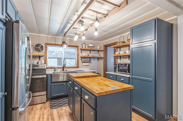 167 Ripley Co Rd Unit Y-3, Doniphan, MO 63935 - kitchen featuring wooden counters, appliances with stainless steel finishes, open shelves, a kitchen island, and a sink