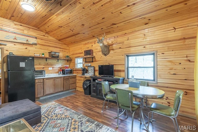 167 Ripley Co Rd Unit Y-3, Doniphan, MO 63935 - kitchen with freestanding refrigerator, vaulted ceiling, wooden walls, stainless steel microwave, and dark wood-style floors