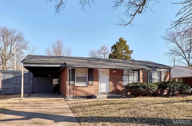 1749 Foley Dr, Saint Louis, MO 63136 - single story home featuring brick siding, concrete driveway, and a carport