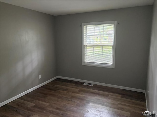 1749 Foley Dr, Saint Louis, MO 63136 - empty room featuring baseboards and dark wood-type flooring