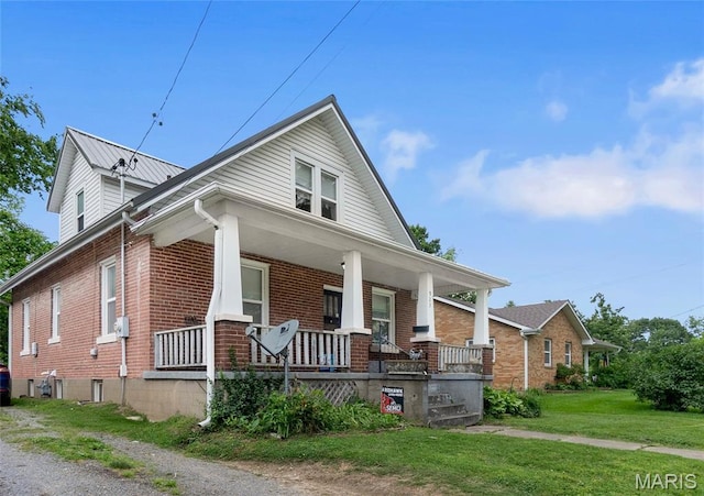 923 N Fountain St, Cape Girardeau, MO 63701 - view of front of property featuring covered porch, brick siding, and a front lawn