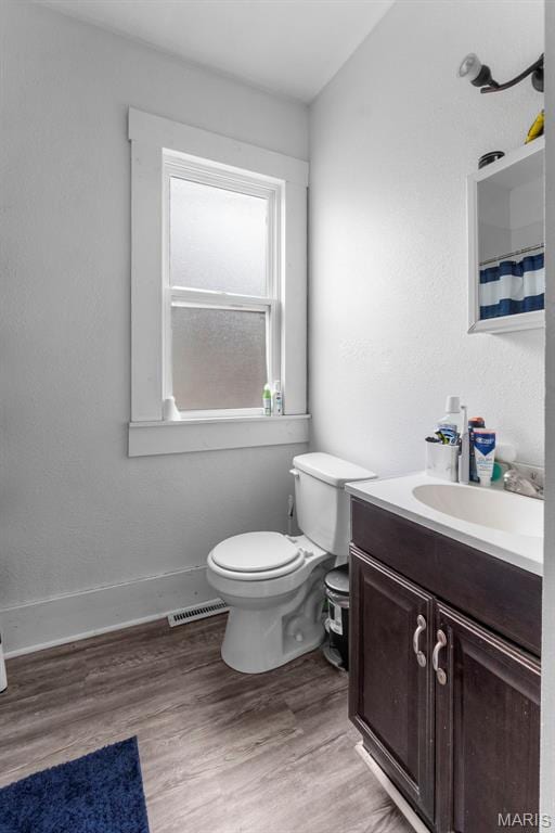 923 N Fountain St, Cape Girardeau, MO 63701 - bathroom featuring toilet, vanity, wood finished floors, and baseboards