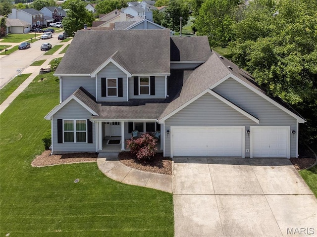 traditional-style home featuring a porch, driveway, roof with shingles, and an attached garage