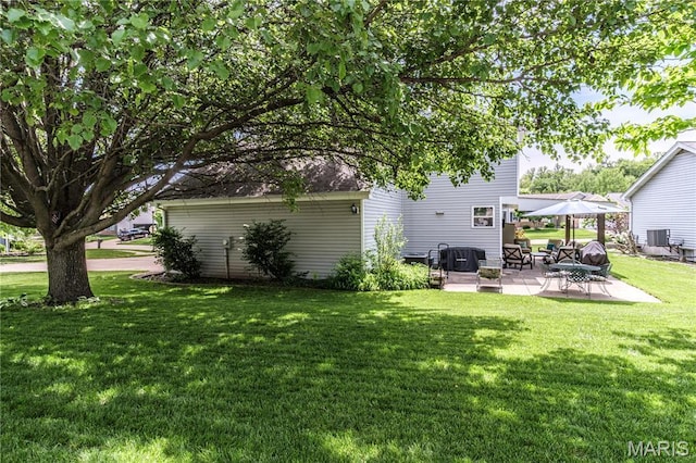 view of grassy yard with a patio