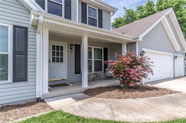 property entrance featuring a porch, an attached garage, driveway, and roof with shingles
