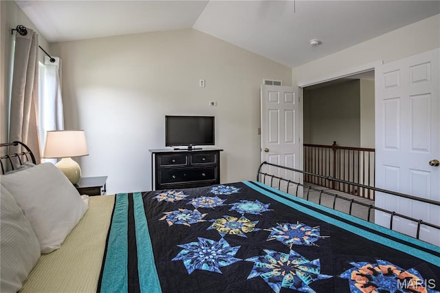 bedroom with lofted ceiling