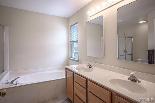 full bath featuring a garden tub, a shower stall, double vanity, and tile patterned floors